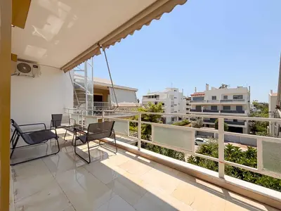 a balcony with chairs and a view of the city at Cozy Flat near Glyfada Center in Athens