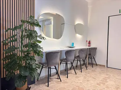 a dining room with a table and chairs and a mirror at Cozy Flat near Glyfada Center in Athens