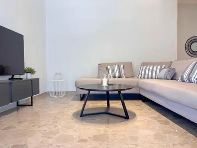 a living room with a couch and a table at Cozy Flat near Glyfada Center in Athens
