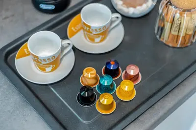 a tray with two cups and saucers on it at CHARĀ Apartment in Plaka, Under The Acropolis in Athens