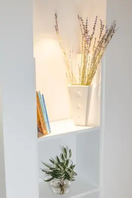 a shelf with two vases and a plant on it at CHARĀ Apartment in Plaka, Under The Acropolis in Athens