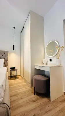 a room with a desk with a mirror and a bed at CHARĀ Apartment in Plaka, Under The Acropolis in Athens