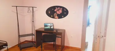 a desk with a laptop and a chair in a room at Dimis Apartment in Athens