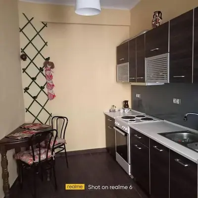 a kitchen with a stove and a sink and a table at Dimis Apartment in Athens