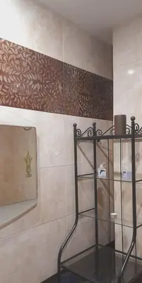a glass shelf in a bathroom with a wall at Dimis Apartment in Athens