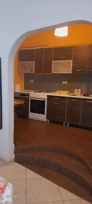 a kitchen with brown cabinets and a white microwave at Dimis Apartment in Athens