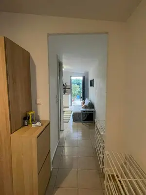 a hallway leading to a living room with a couch at Simple Stay Vari's House in Vari