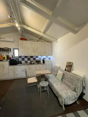 a living room with a couch and a table at Simple Stay Vari's House in Vari