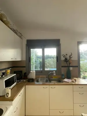 a kitchen with a sink and a microwave at Simple Stay Vari's House in Vari