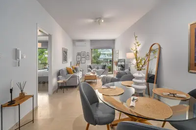 a living room with a table and chairs at The rock view apartment in Athens
