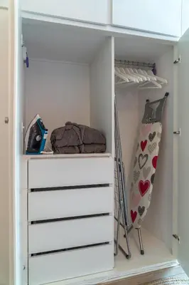 a closet with white drawers and a shelf at The rock view apartment in Athens