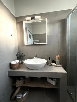 a bathroom with a sink and a mirror at The rock view apartment in Athens