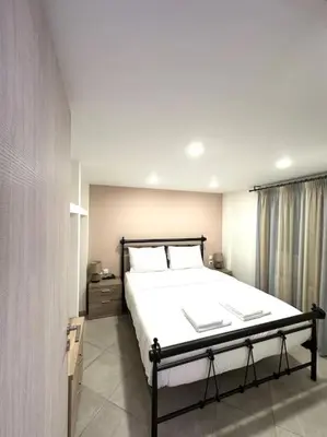 a bedroom with a large bed in a room at Tide and Tonic spacious 1bd apartment with extra Loft Style Sleeping Area, Paleo Faliro in Athens