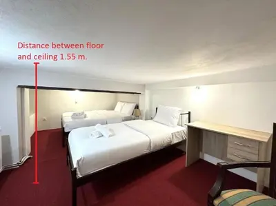 two beds in a hotel room with a difference between at Tide and Tonic spacious 1bd apartment with extra Loft Style Sleeping Area, Paleo Faliro in Athens