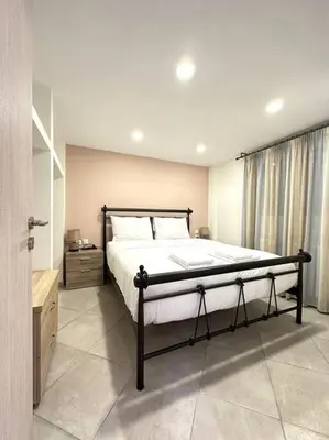 a bedroom with a large bed in a room at Tide and Tonic spacious 1bd apartment with extra Loft Style Sleeping Area, Paleo Faliro in Athens