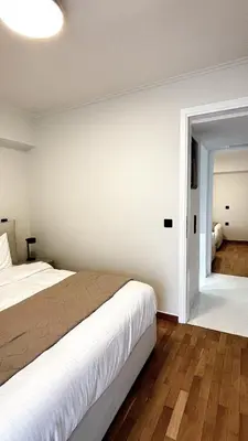 a bedroom with a large bed and a mirror at The White Marble - Spacious, 4BR, 2BA in Paleo Faliro in Athens