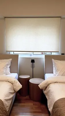 two beds sitting next to each other in a room at The White Marble - Spacious, 4BR, 2BA in Paleo Faliro in Athens