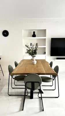 a dining room with a wooden table and chairs at The White Marble - Spacious, 4BR, 2BA in Paleo Faliro in Athens