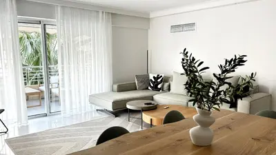 a living room with a table and a couch at The White Marble - Spacious, 4BR, 2BA in Paleo Faliro in Athens