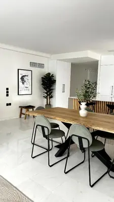 a dining room with a wooden table and two chairs at The White Marble - Spacious, 4BR, 2BA in Paleo Faliro in Athens