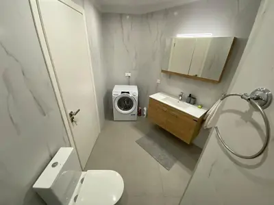 a bathroom with a washing machine and a washer and dryer at Ydrea Piraeus port apartment in Piraeus