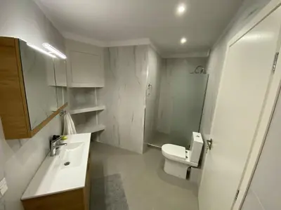 a small bathroom with a toilet and a sink at Ydrea Piraeus port apartment in Piraeus