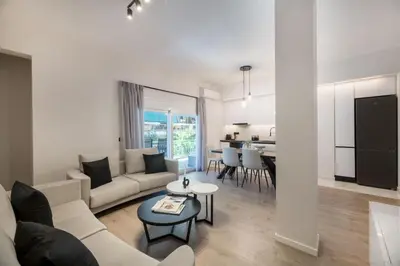 a living room with a couch and a table at Lovely 3BR Apartment in Pangrati by UPSTREET in Athens