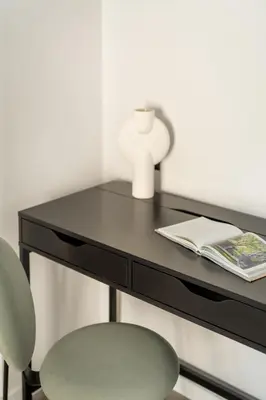 a black desk with a chair and a book at Lovely 3BR Apartment in Pangrati by UPSTREET in Athens