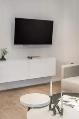 a living room with a tv and a coffee table at Lovely 3BR Apartment in Pangrati by UPSTREET in Athens