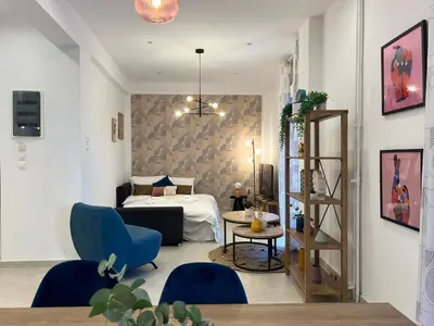 a bedroom with a bed and a table and chairs at NEW! Incredible 1BR Apt in Koukaki with AC in Athens
