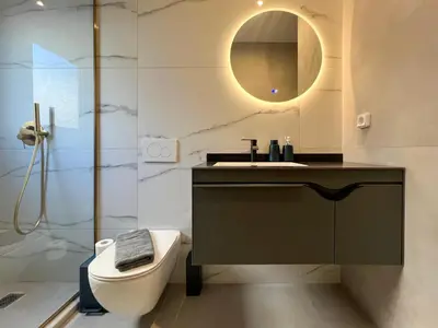 a bathroom with a sink and a toilet and a mirror at NEW! Incredible 1BR Apt in Koukaki with AC in Athens