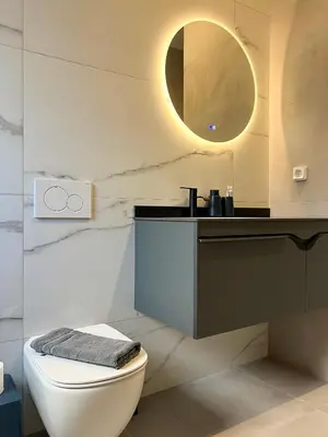 a bathroom with a toilet and a sink and a mirror at NEW! Incredible 1BR Apt in Koukaki with AC in Athens