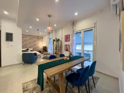 a dining room and living room with a table and chairs at NEW! Incredible 1BR Apt in Koukaki with AC in Athens