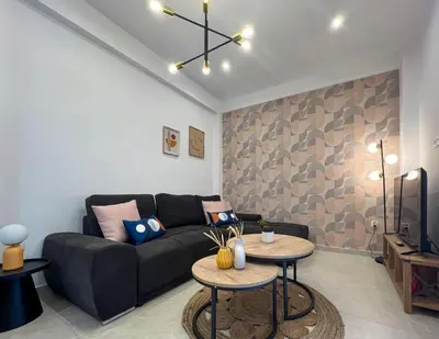 a living room with a couch and two tables at NEW! Incredible 1BR Apt in Koukaki with AC in Athens