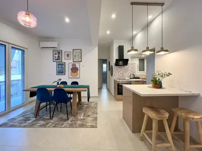 a kitchen and dining room with a table and chairs at NEW! Incredible 1BR Apt in Koukaki with AC in Athens