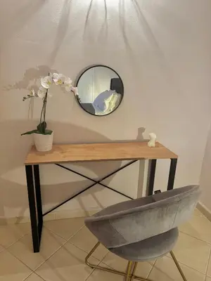 a mirror on top of a table with a chair at DOLCE VITA LUXURY APARTMENT Markopoulo in Markopoulo