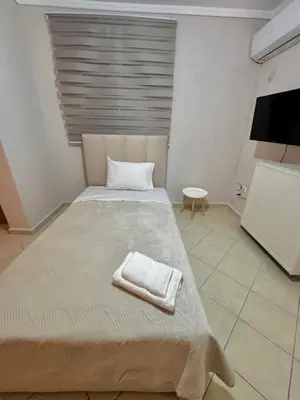 a bedroom with a large bed with a towel on it at DOLCE VITA LUXURY APARTMENT Markopoulo in Markopoulo