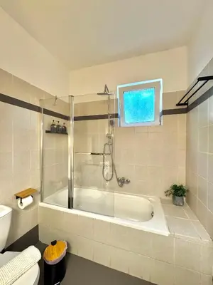 a bathroom with a bath tub and a toilet at DOLCE VITA LUXURY APARTMENT Markopoulo in Markopoulo