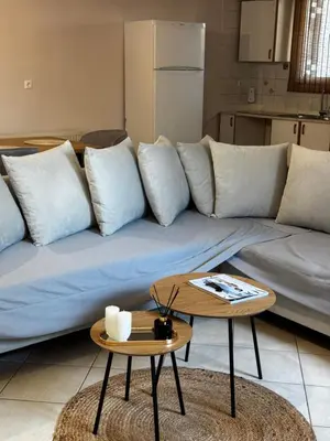 a living room with a couch and two tables at DOLCE VITA LUXURY APARTMENT Markopoulo in Markopoulo