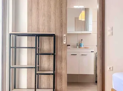 a room with a kitchen with a glass door at Light & Spacious Apartment near Glyfada Center in Athens
