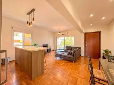 a large living room with a couch and a table at Light & Spacious Apartment near Glyfada Center in Athens