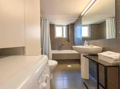 a bathroom with a sink and a toilet and a tub at Light & Spacious Apartment near Glyfada Center in Athens