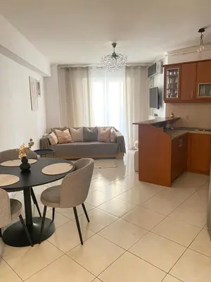 a living room with a couch and a table and chairs at Cozy home in Piraeus