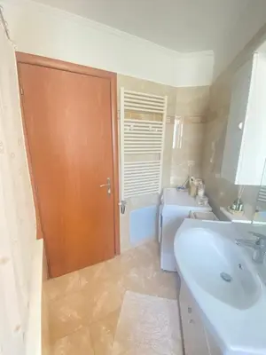 a bathroom with a sink and a tub at Cozy home in Piraeus