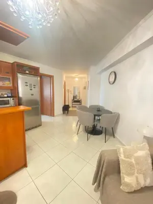 a kitchen and a living room with a table and chairs at Cozy home in Piraeus