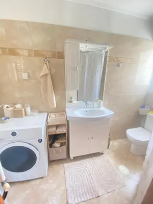 a bathroom with a sink and a washing machine at Cozy home in Piraeus