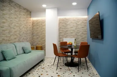 a living room with a couch and a table with chairs at Modern Style Suite VIPGreece in Athens