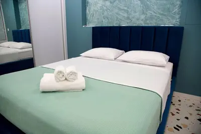 a bedroom with a bed with towels on it at Modern Style Suite VIPGreece in Athens