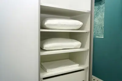 a closet with white shelves with pillows on them at Modern Style Suite VIPGreece in Athens