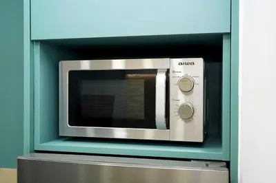 a microwave oven sitting inside of a blue wall at Modern Style Suite VIPGreece in Athens